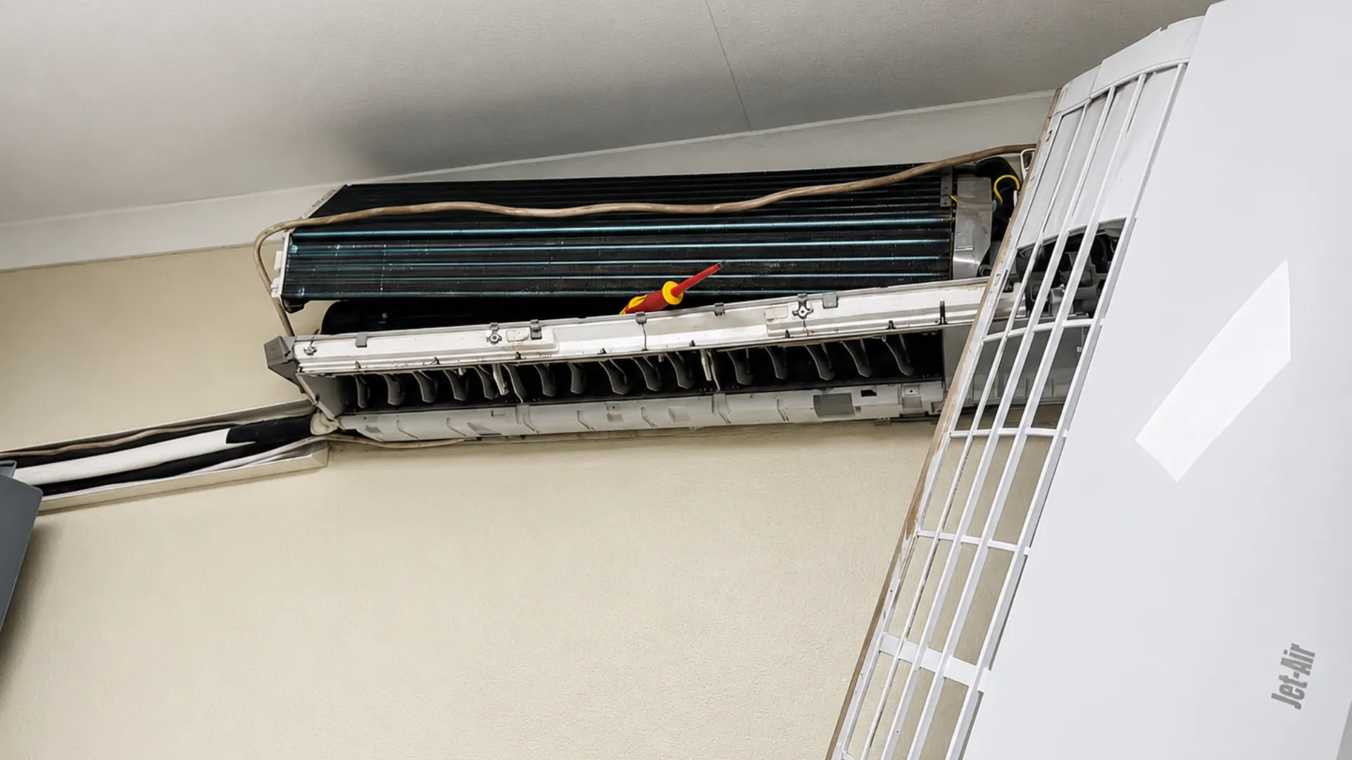 Opened indoor wall-mounted air conditioner during repair inspection